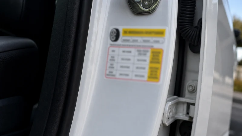 Driver-side door jamb tire pressure sticker showing recommended front and rear PSI