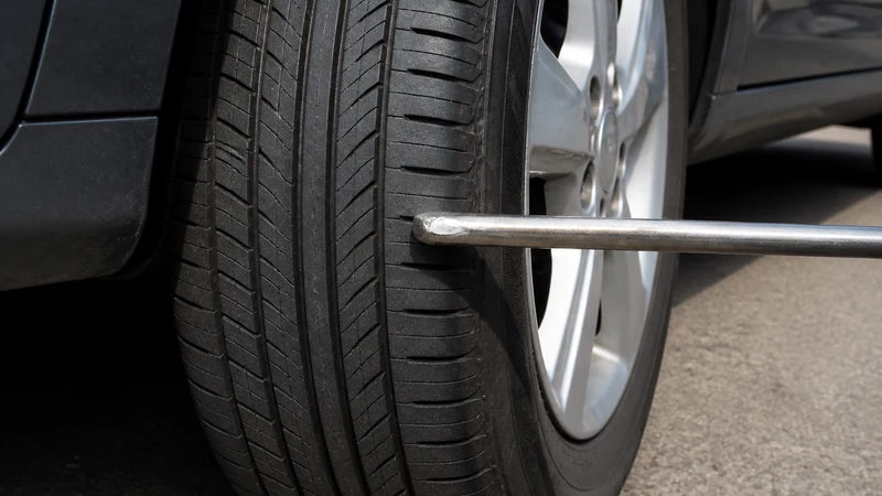 Thump test — tapping a tire tread with a tire iron to listen for a sharp thwack or dull thud